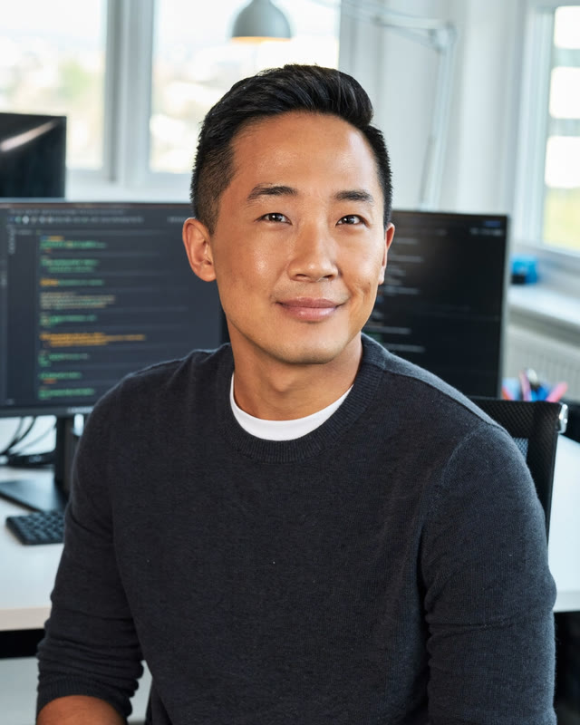AI-generated portrait: software developer at his desk, code on the screens