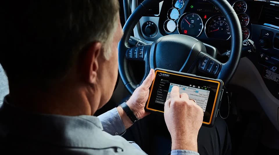 Driver logging hours on an ISAAC ELD tablet in the cab
